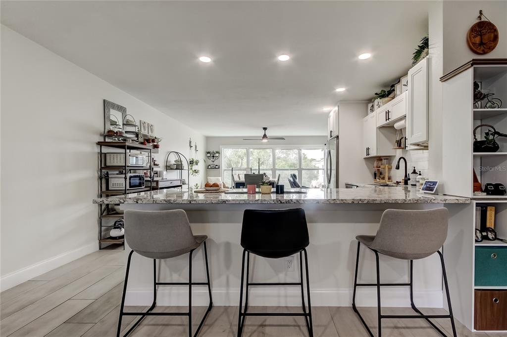 2170 Americus Boulevard North, Unit 64 Clearwater, FL 33763 - Photo 7 of 66 a kitchen view with stainless steel appliances kitchen island granite countertop a sink and cabinets