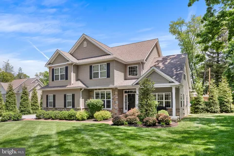 a front view of a house with a yard and potted plants