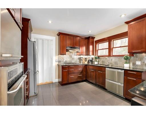 95 Welland Road Brookline, MA 02445 - Photo 10 of 28 a kitchen with granite countertop wooden cabinets stainless steel appliances a sink and a window