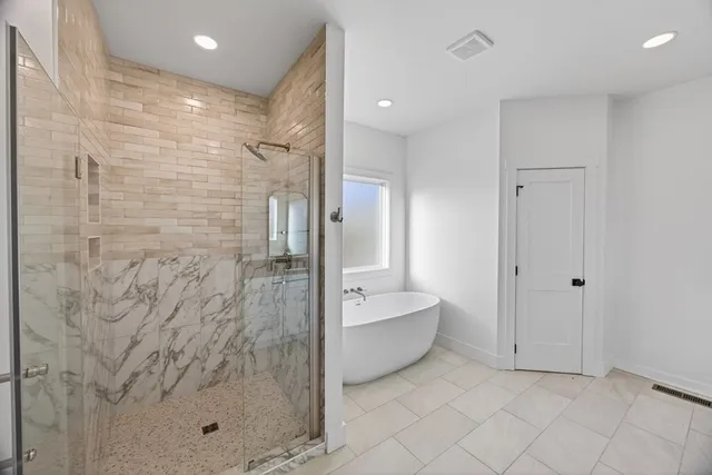 a bathroom with a bathtub and shower