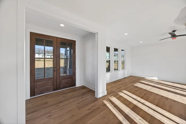 a view of an empty room with glass door