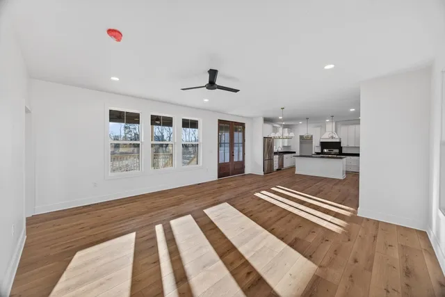 a view of an empty room with kitchen