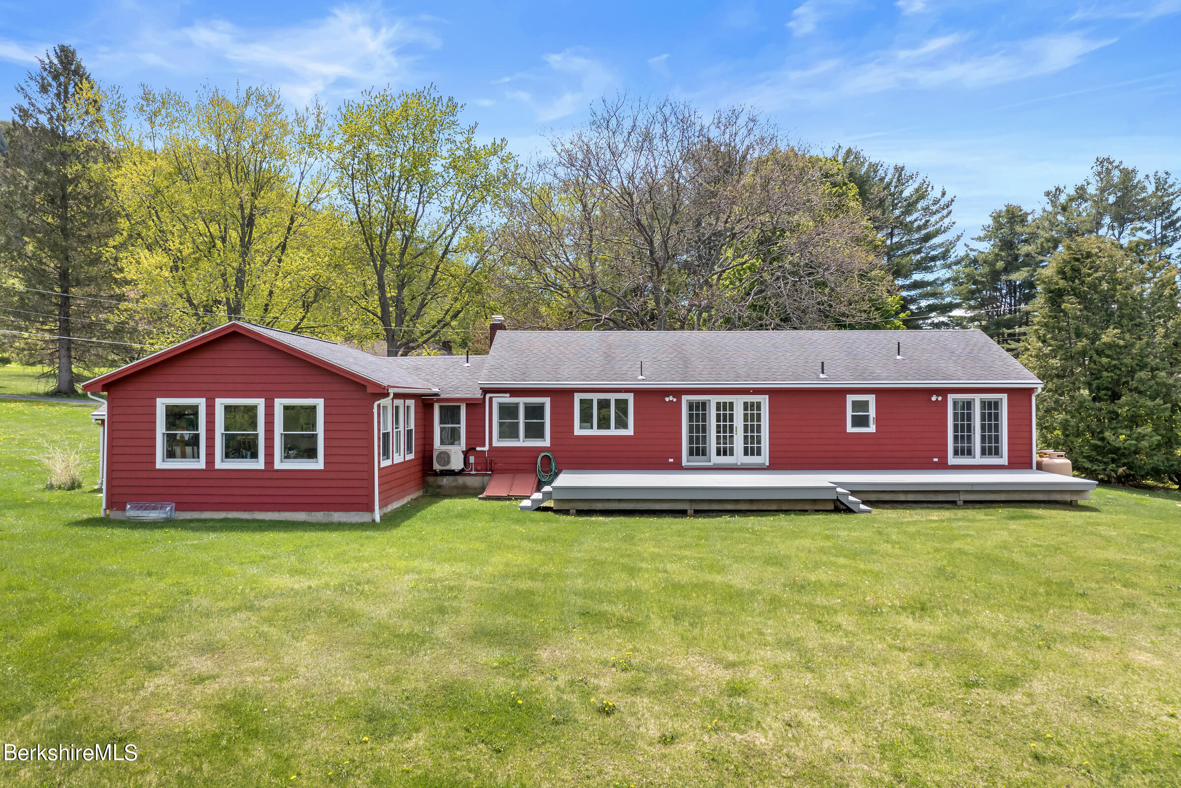 79 View Drive Richmond, MA 01201 - Photo 5 of 34 a house that is sitting in the grass with large trees and plants