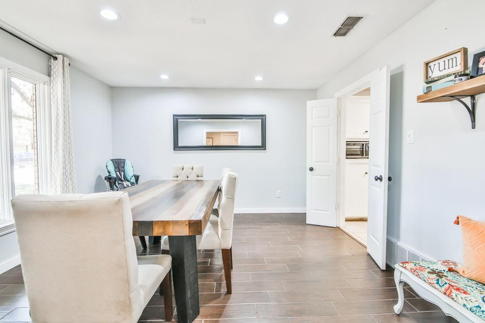 4915 79th Street Lubbock, TX 79424 - Photo 6 of 37 a view of a dining room with furniture and a chandelier