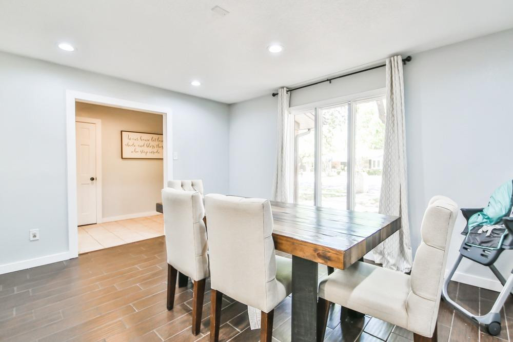 4915 79th Street Lubbock, TX 79424 - Photo 7 of 37 a view of a dining room with furniture window and wooden floor