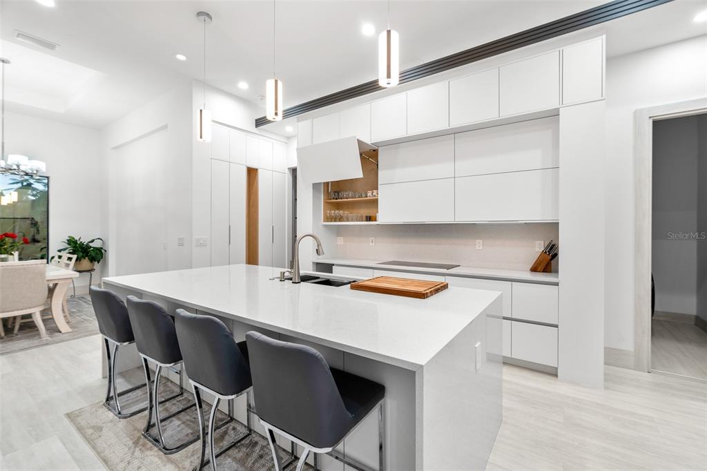 380 Cowry Road Venice, FL 34293 - Photo 16 of 44 a kitchen with stainless steel appliances a white stove top oven table and chairs