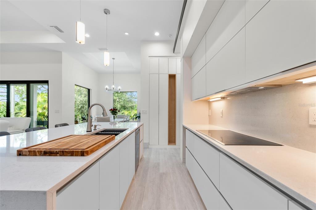 380 Cowry Road Venice, FL 34293 - Photo 18 of 44 a large kitchen with kitchen island a large counter top space a sink stainless steel appliances and windows