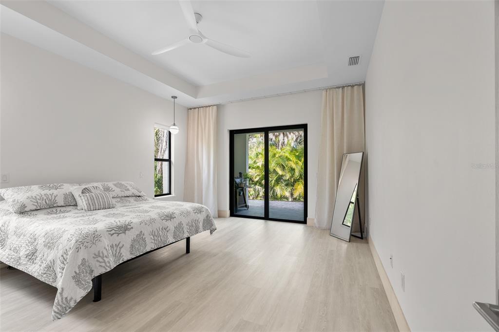 380 Cowry Road Venice, FL 34293 - Photo 21 of 44 a spacious bedroom with a bed and a large window