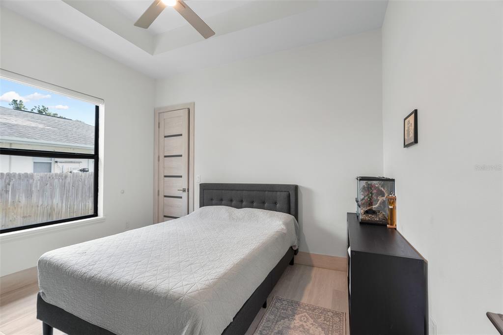 380 Cowry Road Venice, FL 34293 - Photo 26 of 44 a bedroom with a bed and wooden floor