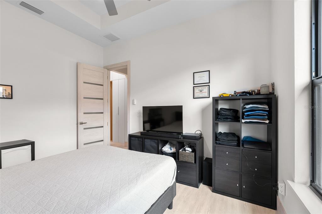 380 Cowry Road Venice, FL 34293 - Photo 27 of 44 a bedroom with a bed and a flat screen tv