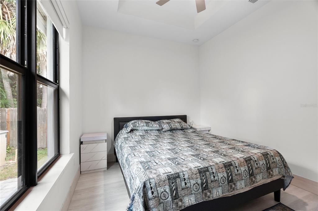 380 Cowry Road Venice, FL 34293 - Photo 30 of 44 a bed sitting in a bedroom next to a window