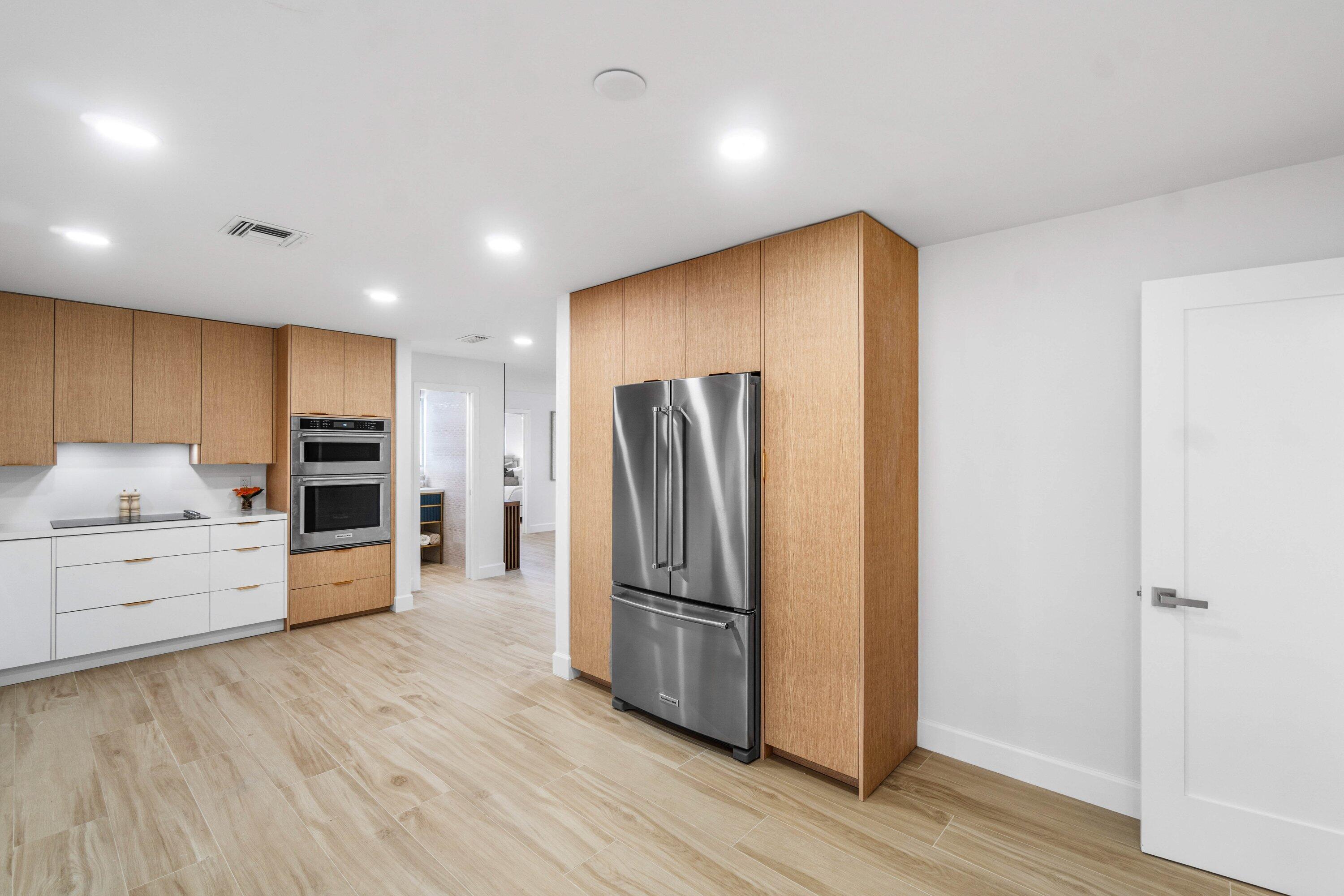 2634 Southwest 5th Street Boynton Beach, FL 33435 - Photo 11 of 57 a kitchen with stainless steel appliances a refrigerator and a stove top oven