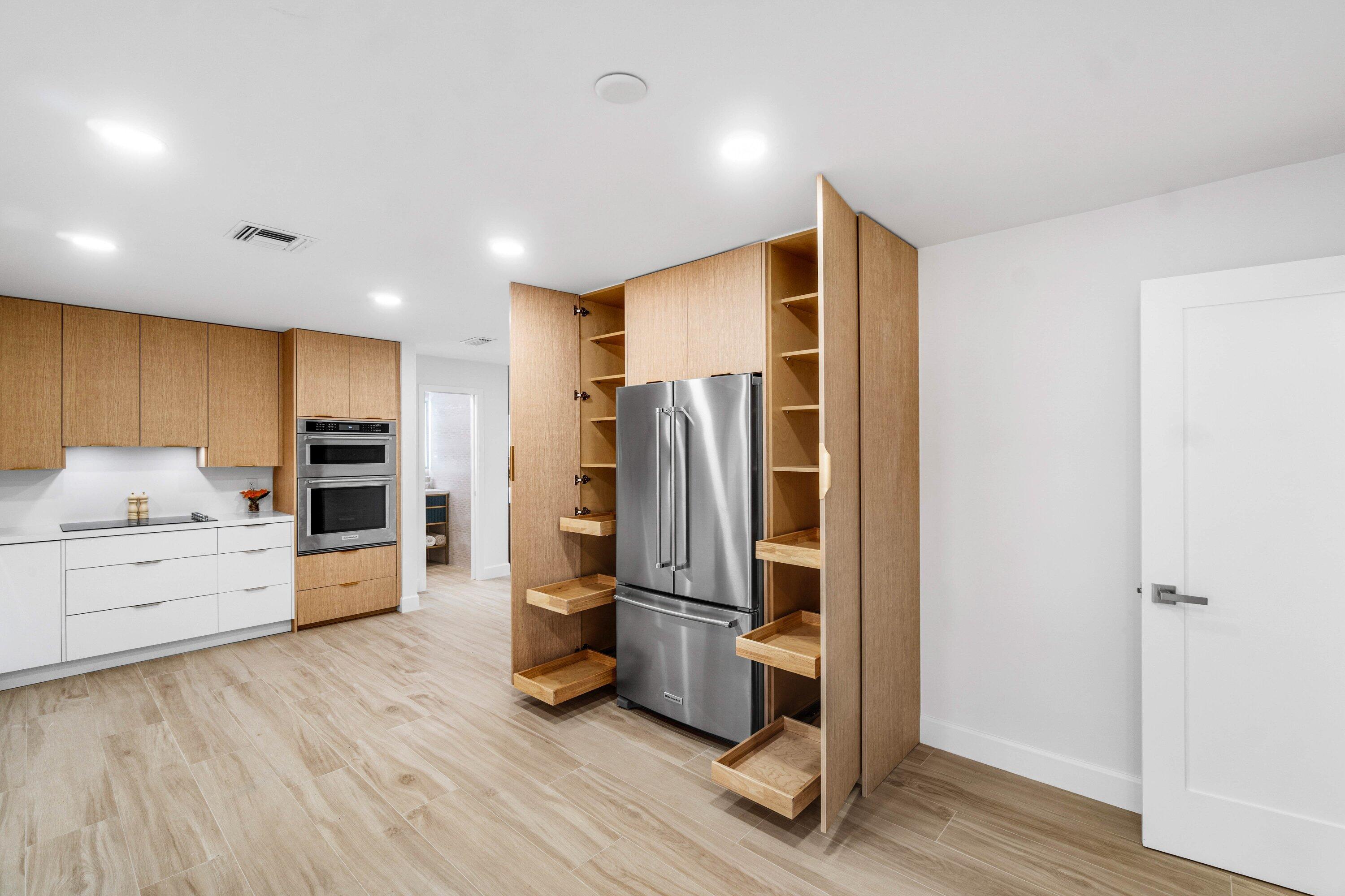 2634 Southwest 5th Street Boynton Beach, FL 33435 - Photo 12 of 57 a kitchen with stainless steel appliances a refrigerator and a stove top oven