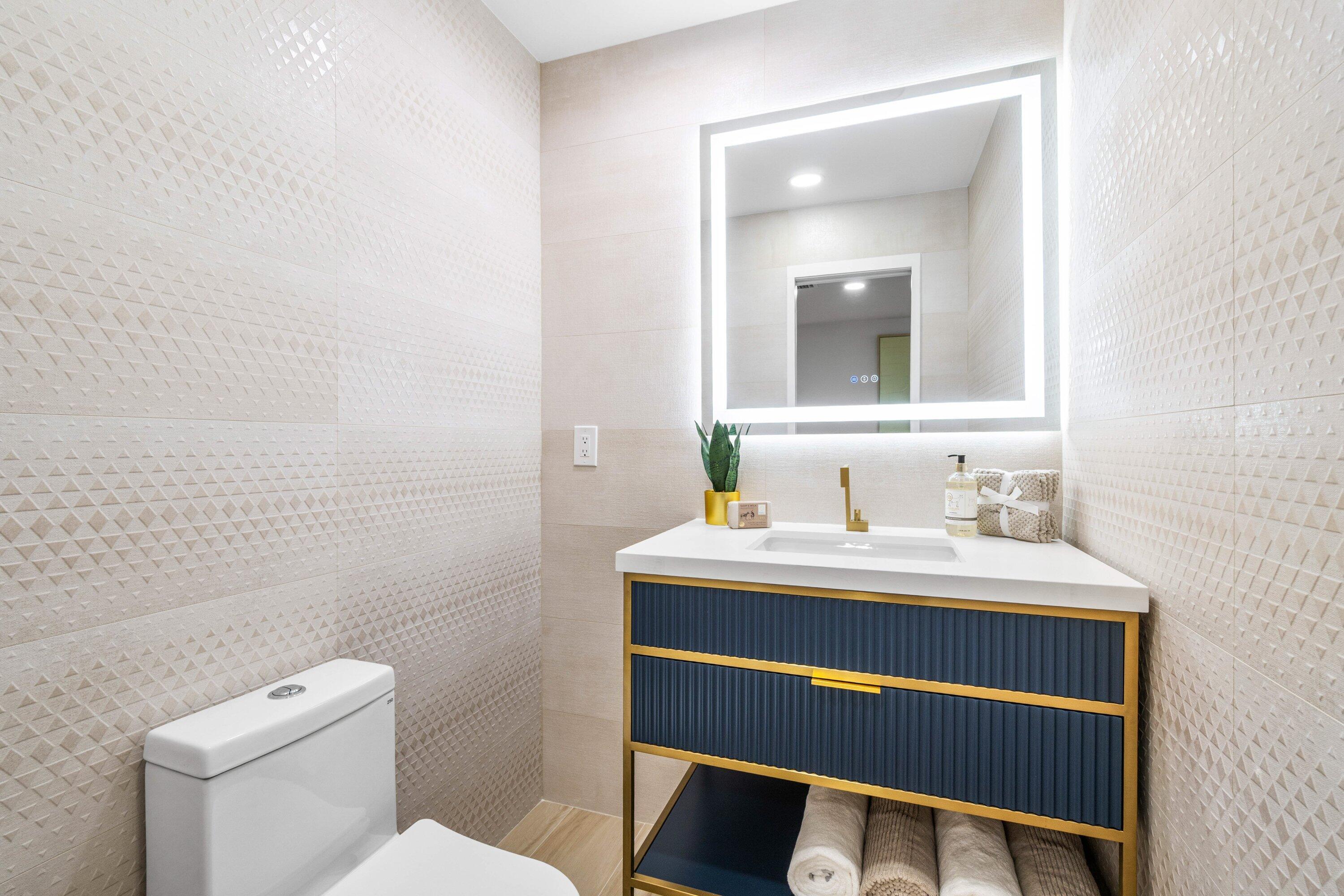 2634 Southwest 5th Street Boynton Beach, FL 33435 - Photo 17 of 57 a bathroom with a sink a toilet and mirror