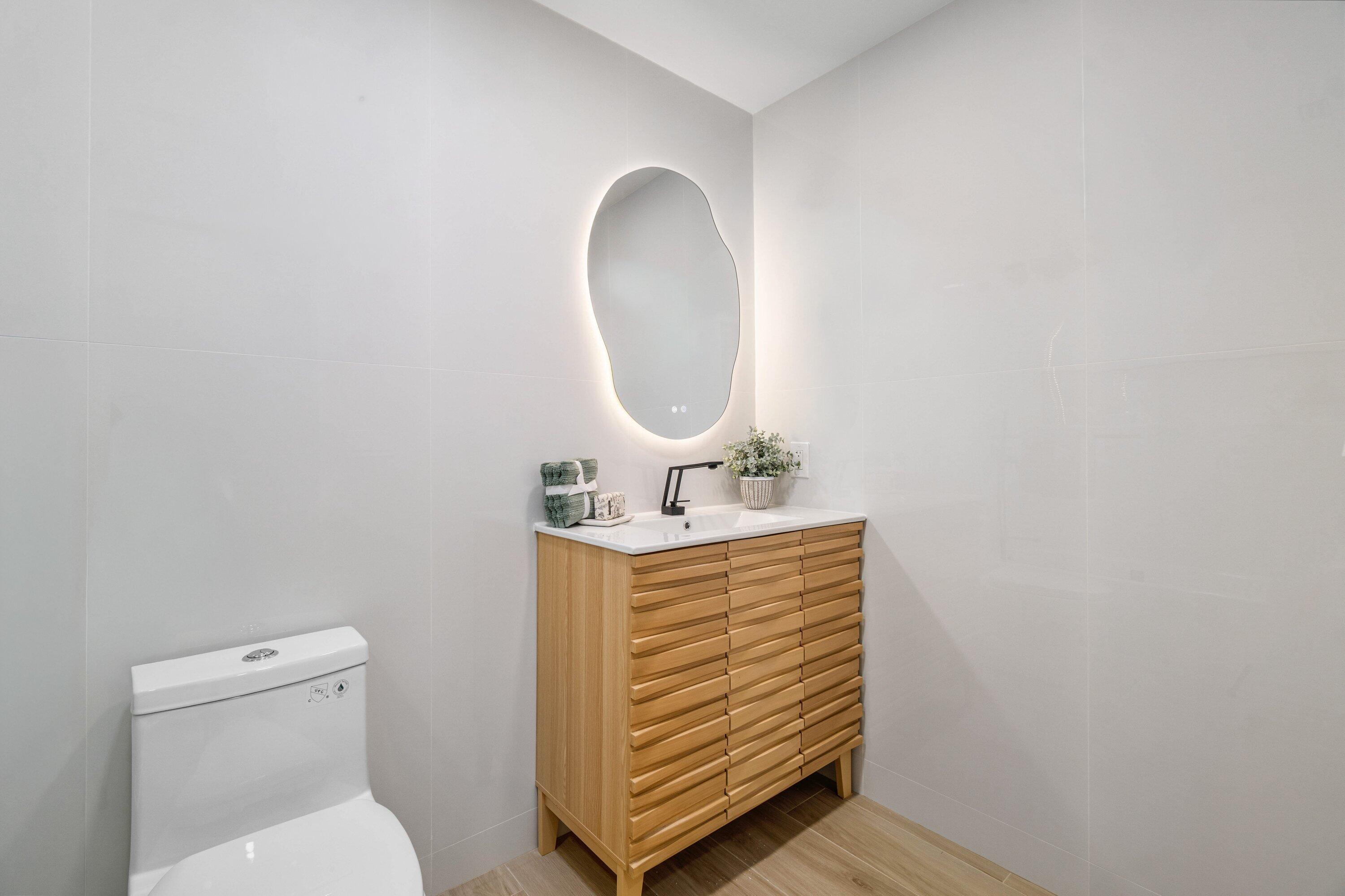 2634 Southwest 5th Street Boynton Beach, FL 33435 - Photo 27 of 57 a bathroom with a sink a toilet and a mirror