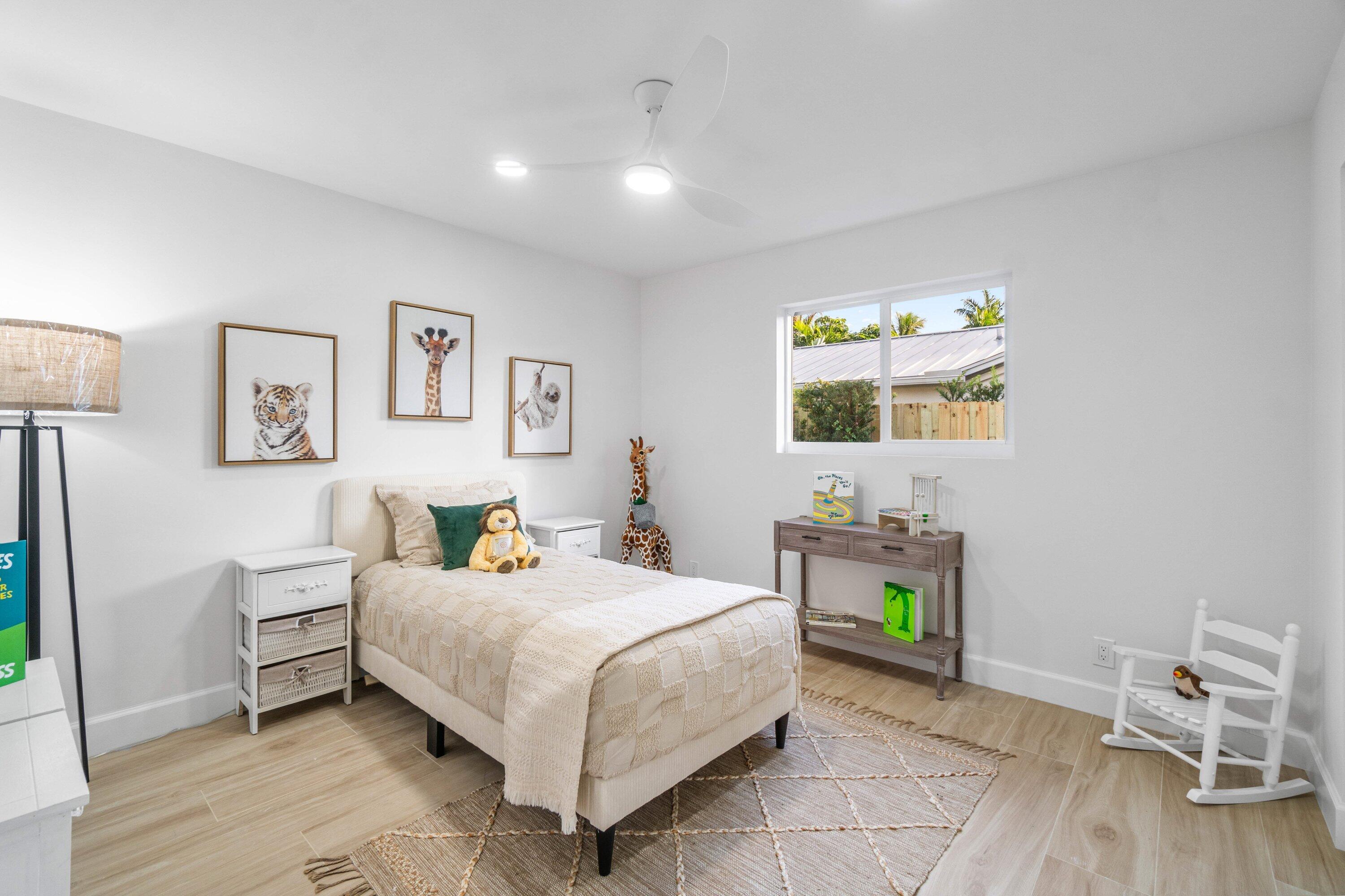 2634 Southwest 5th Street Boynton Beach, FL 33435 - Photo 29 of 57 a bedroom with a bed and a table in it