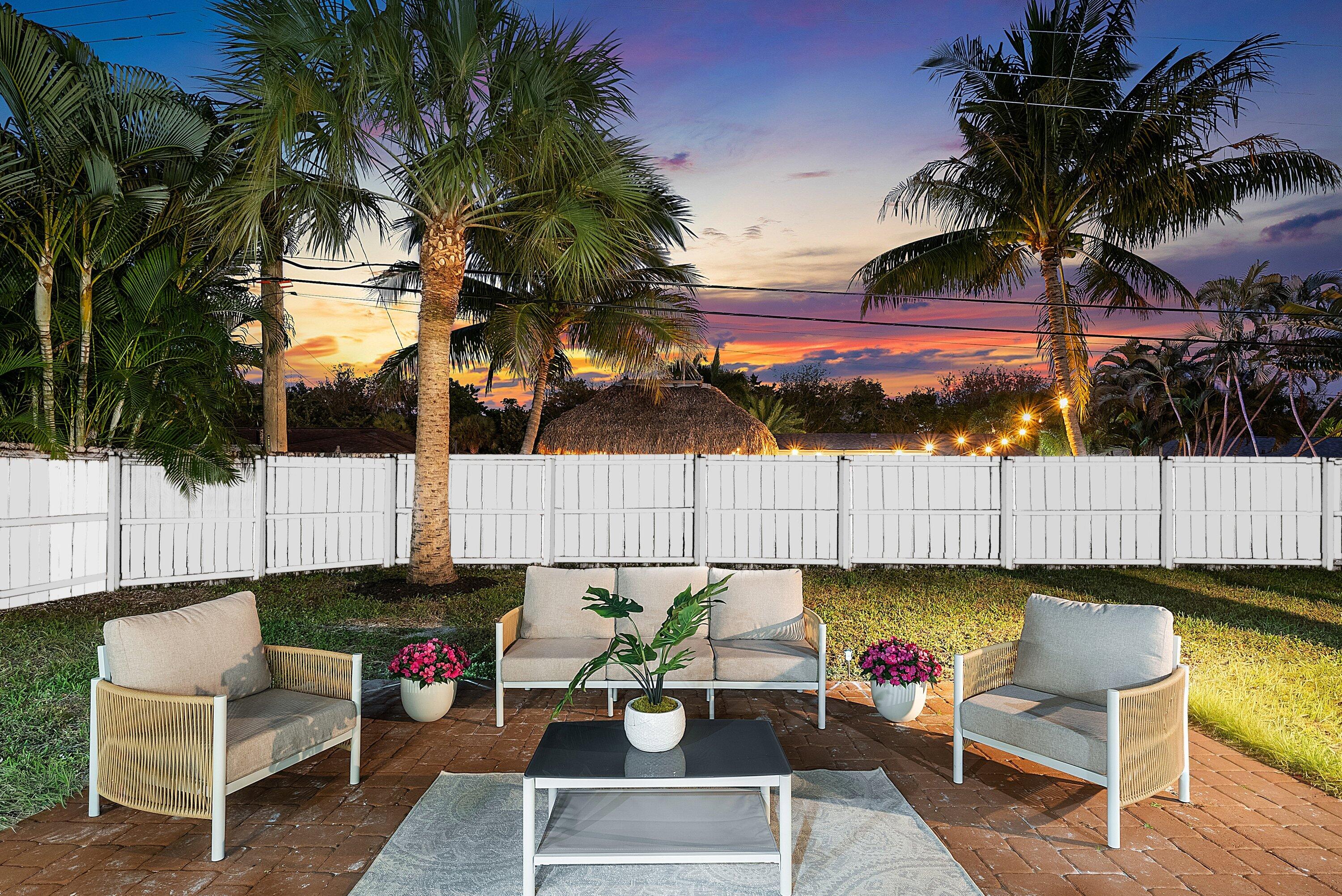 2634 Southwest 5th Street Boynton Beach, FL 33435 - Photo 43 of 57 a view of a patio with couches a table and chairs and wooden fence