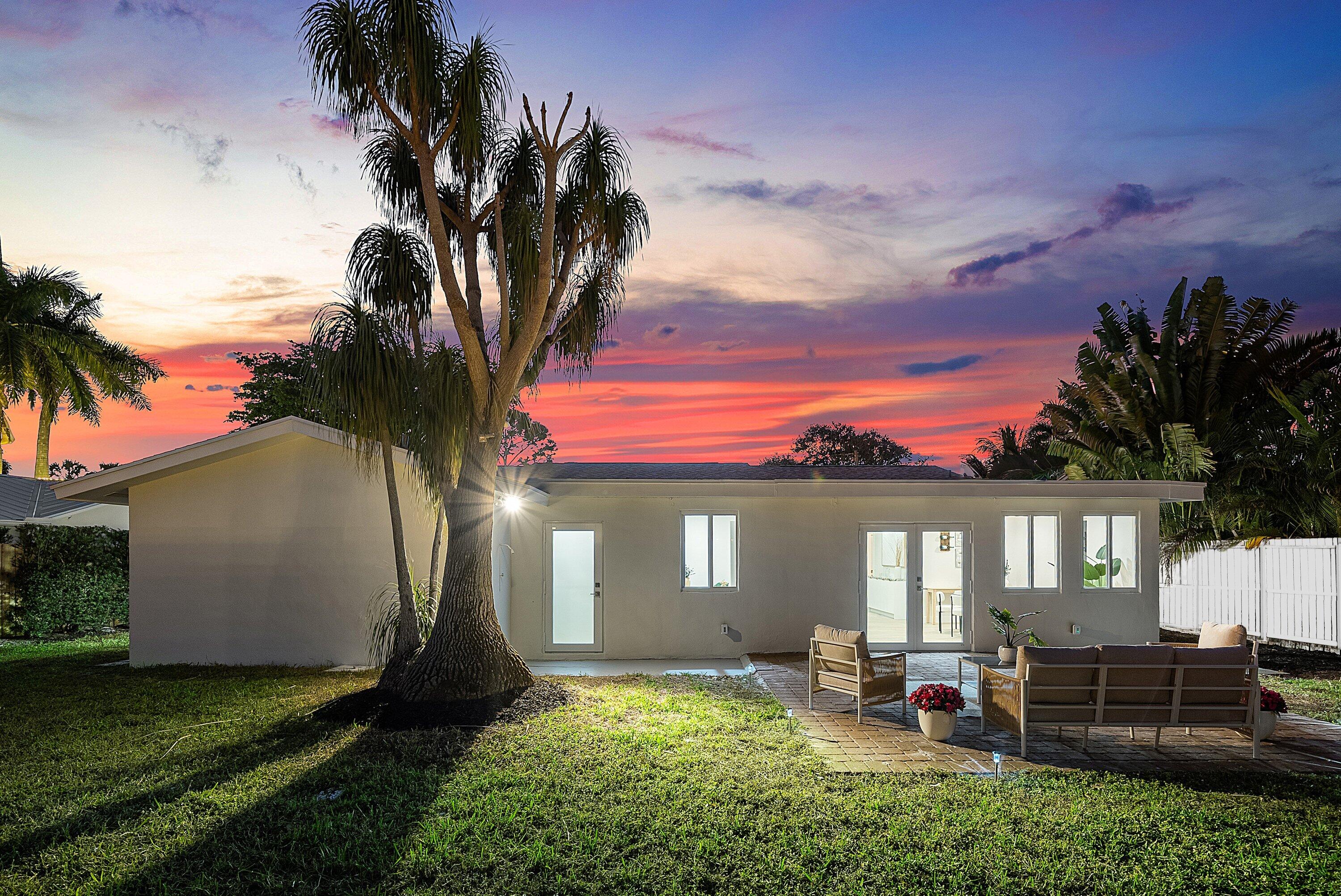 2634 Southwest 5th Street Boynton Beach, FL 33435 - Photo 48 of 57 a front view of a house with a garden and yard