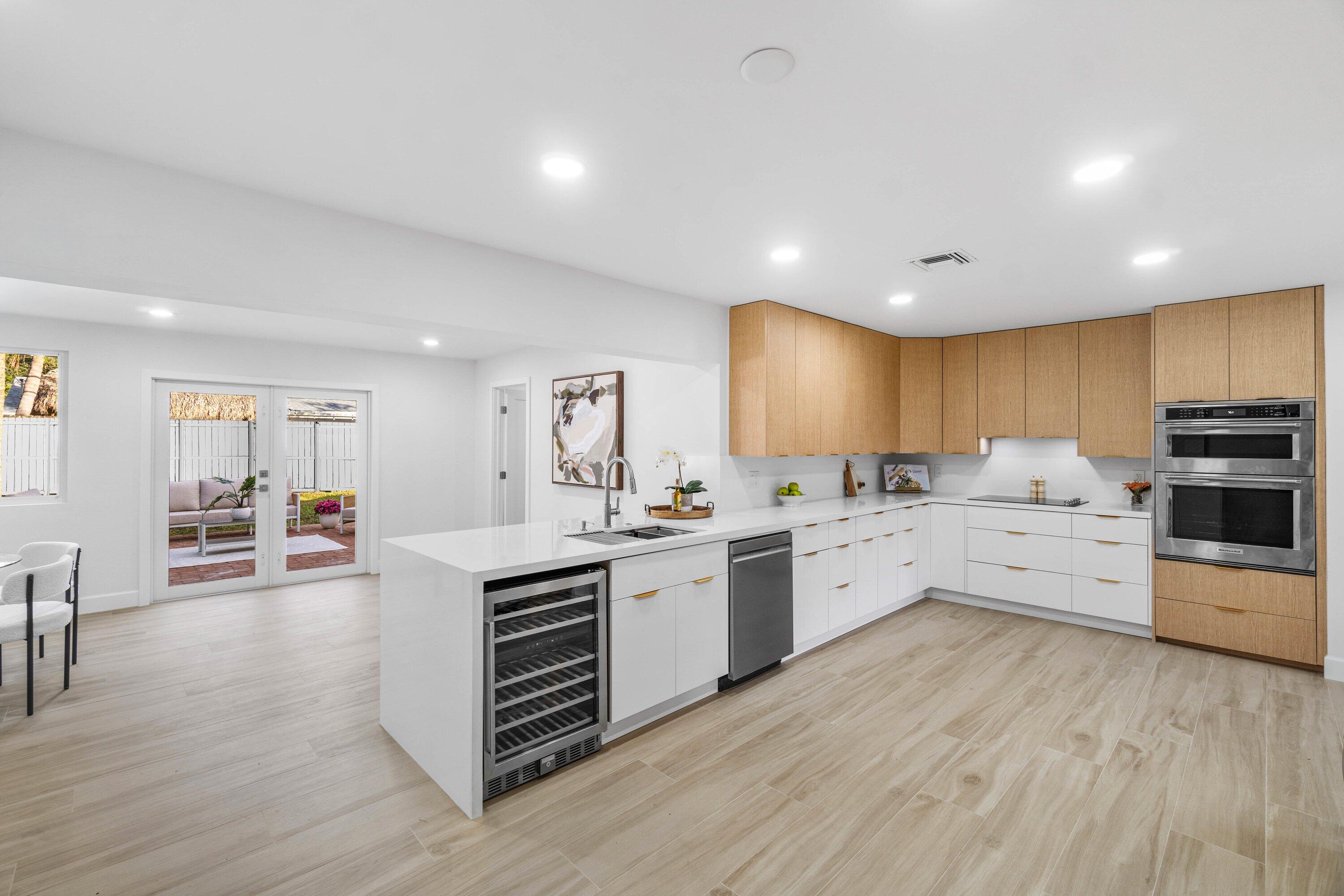 2634 Southwest 5th Street Boynton Beach, FL 33435 - Photo 9 of 57 a large white kitchen with lots of counter space a sink and appliances