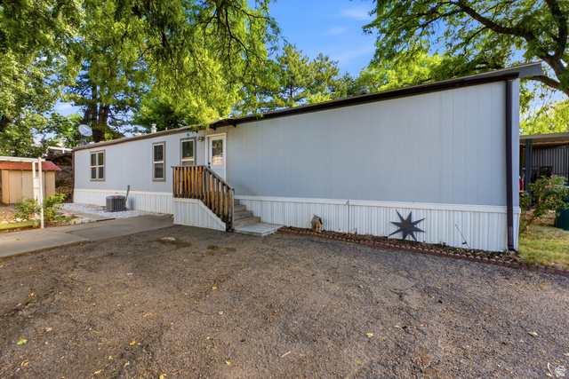 2875 North Hill Field Road, Unit 62 Layton, UT 84041 - Photo 3 of 34 Manufactured home with light-colored siding and white skirting