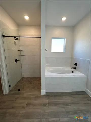 a bathroom with a bathtub and shower