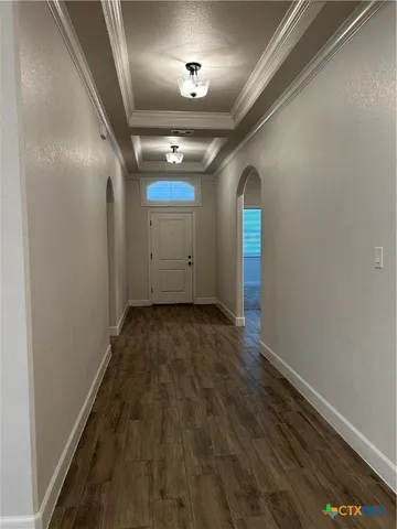 a view of a room with wooden floor