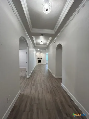 a view of empty room with wooden floor