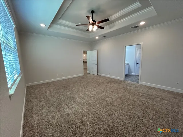 en empty room with window and ceiling fan