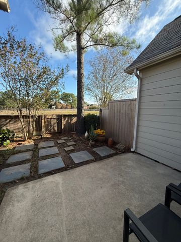 a view of a patio with table and chairs and potted plants