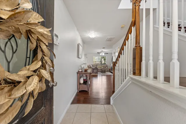 a view of a hallway with wooden floor and stairs