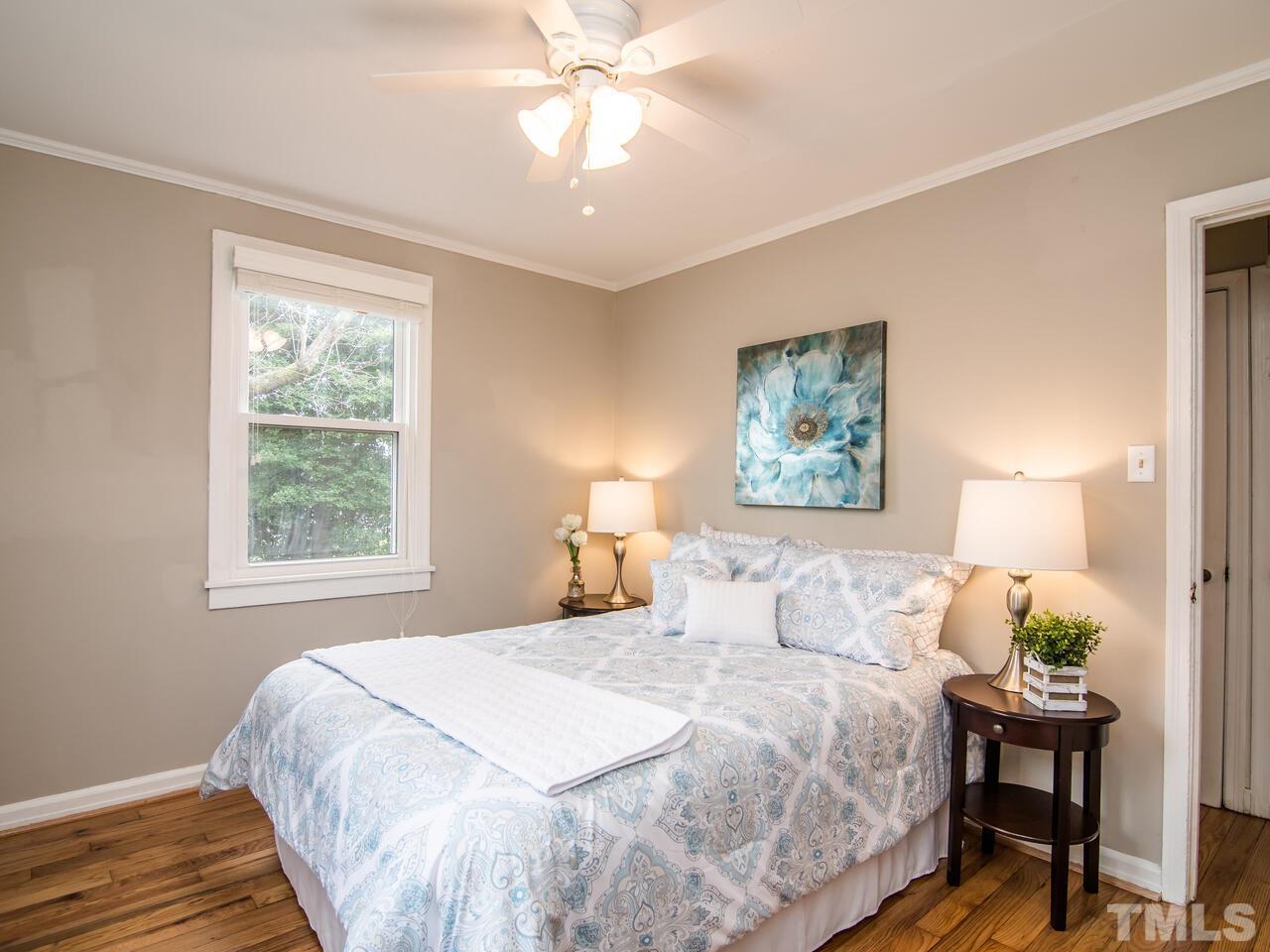 1706 Patton Road Raleigh, NC 27608 - Photo 14 of 22 a bedroom with a bed and a window