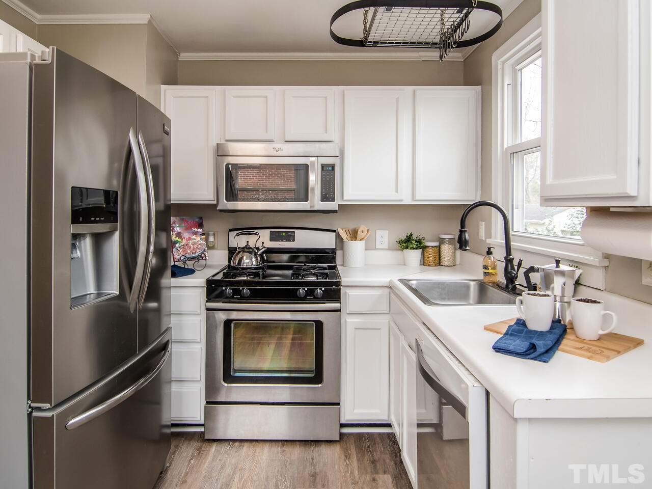 1706 Patton Road Raleigh, NC 27608 - Photo 7 of 22 a kitchen with a refrigerator stove and microwave
