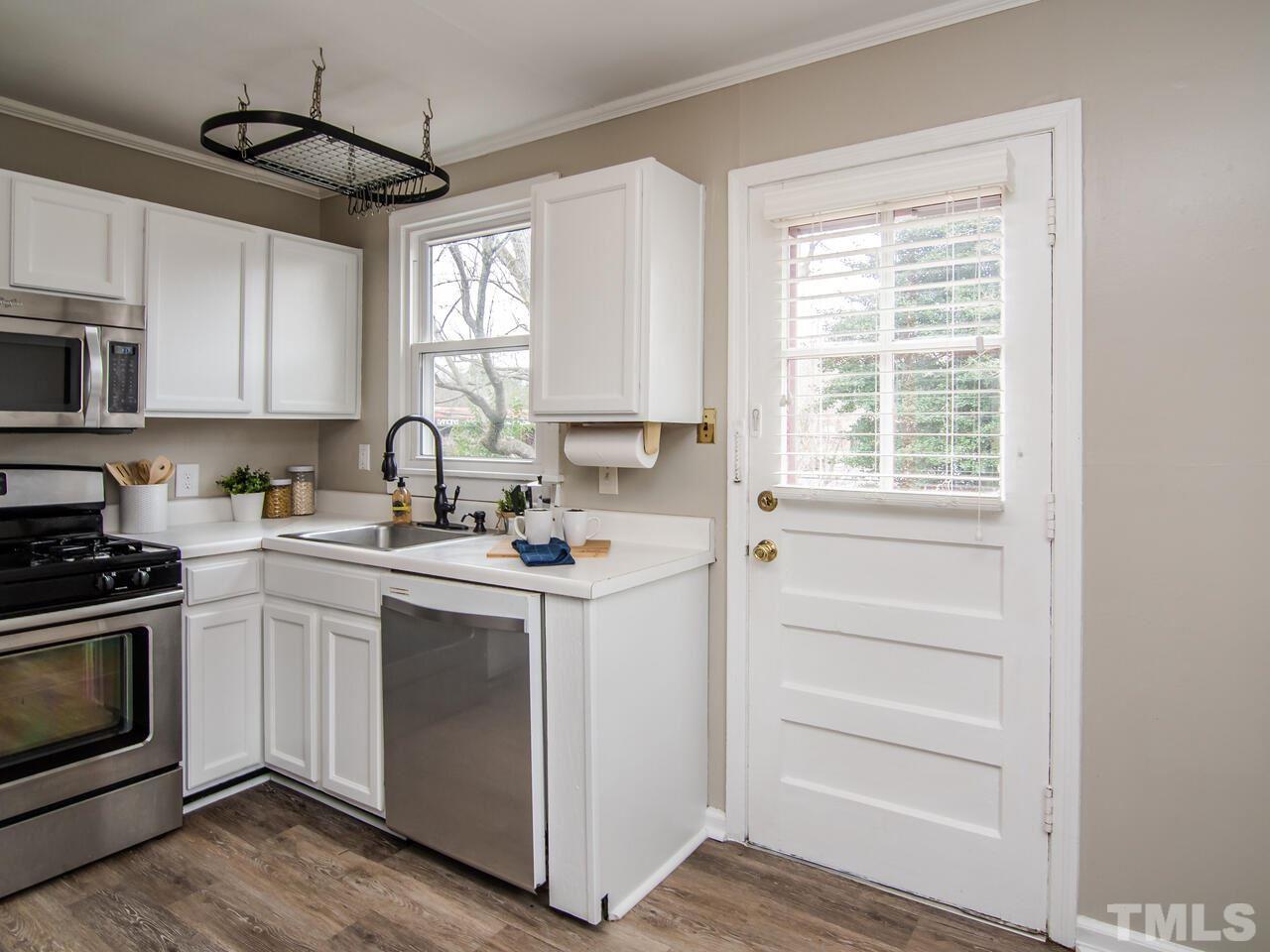 1706 Patton Road Raleigh, NC 27608 - Photo 8 of 22 a kitchen with stove cabinets and window