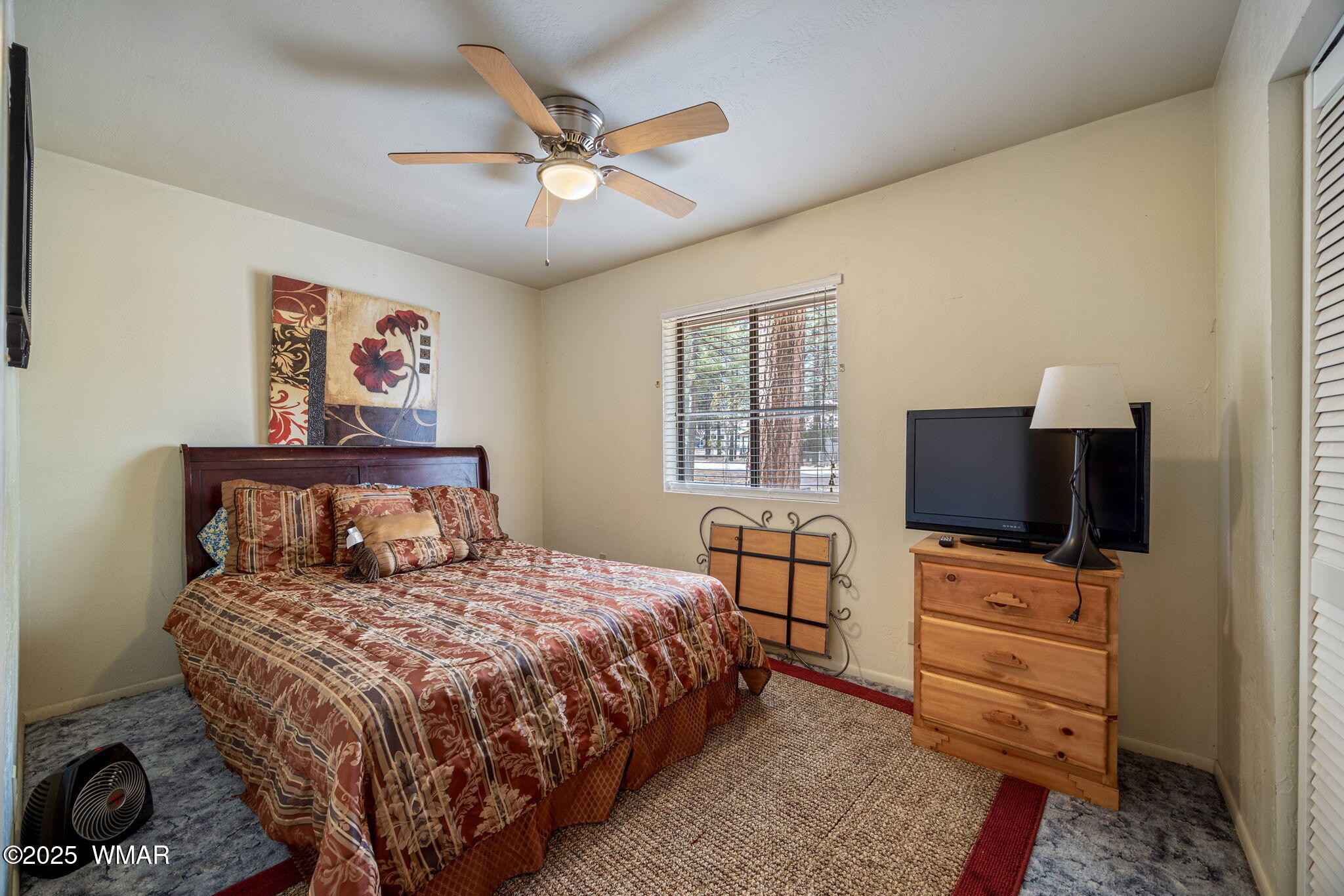 2051 Lumber Valley Road Overgaard, AZ 85933 - Photo 18 of 30 a bedroom with a bed and a flat screen tv