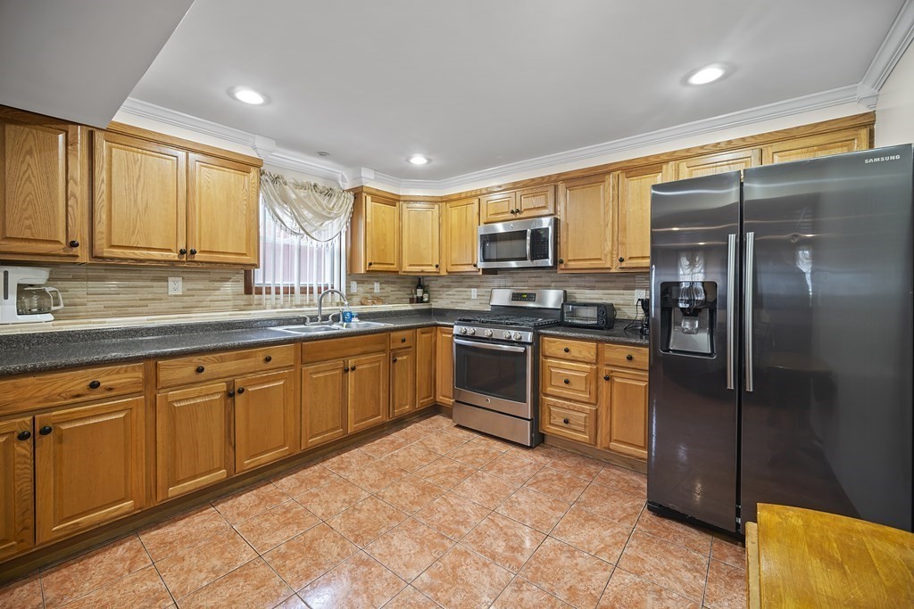 44 Judson Street Fall River, MA 02721 - Photo 21 of 31 a kitchen with stainless steel appliances granite countertop a refrigerator and a stove top oven