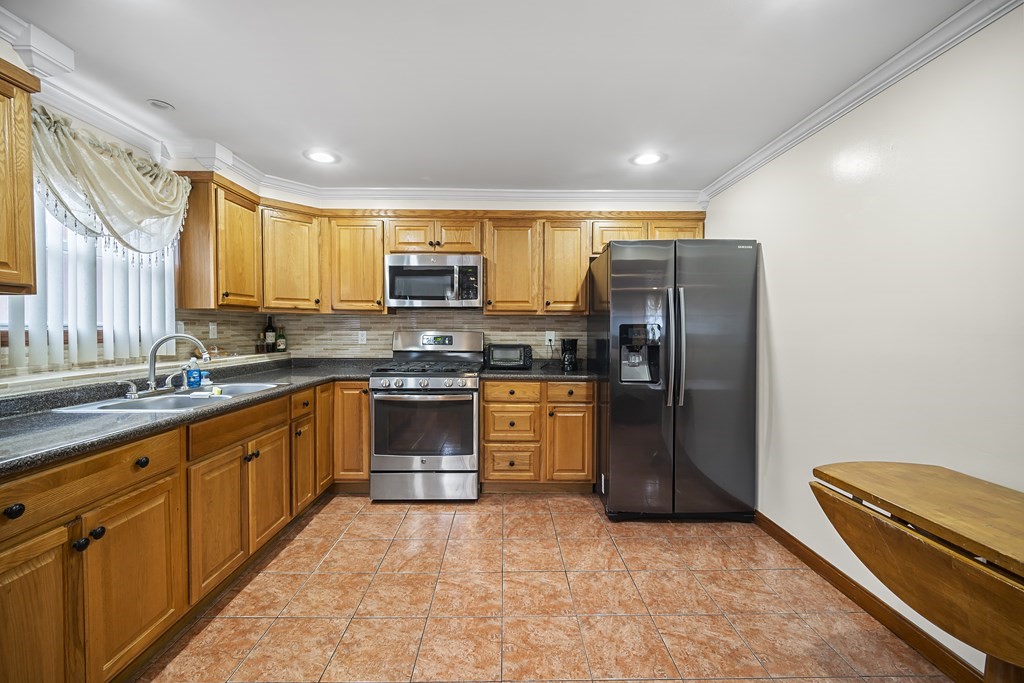 44 Judson Street Fall River, MA 02721 - Photo 22 of 31 a kitchen with stainless steel appliances granite countertop a refrigerator and a stove top oven