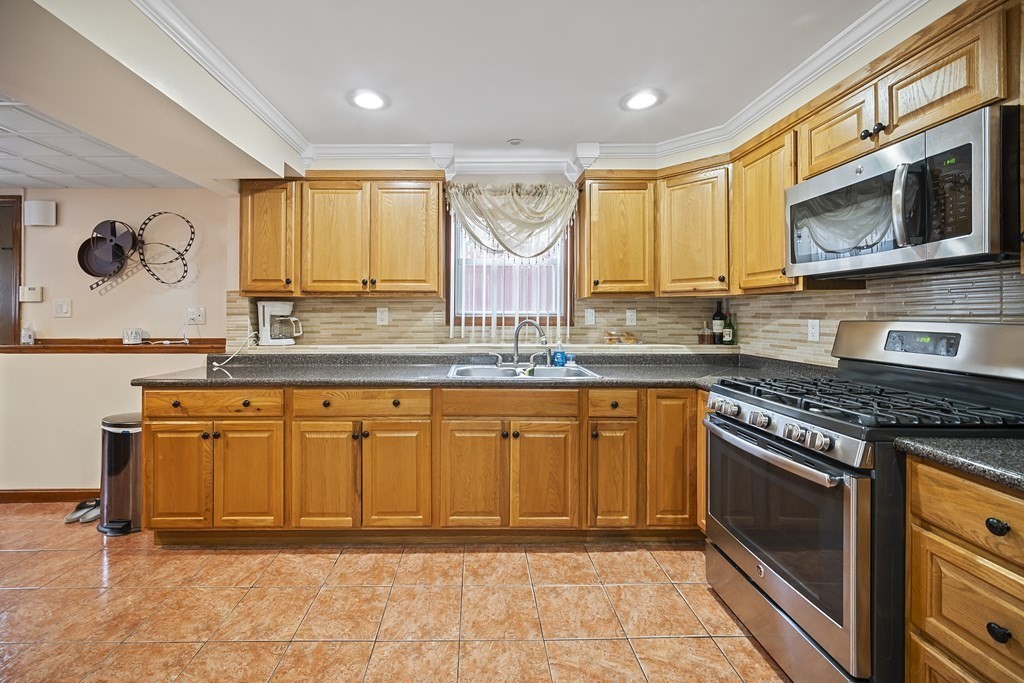 44 Judson Street Fall River, MA 02721 - Photo 23 of 31 a kitchen with stainless steel appliances granite countertop a stove a sink and a microwave