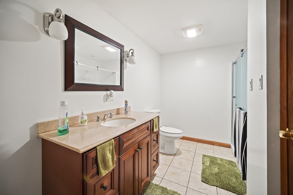 44 Judson Street Fall River, MA 02721 - Photo 26 of 31 a bathroom with a sink a toilet a mirror and vanity