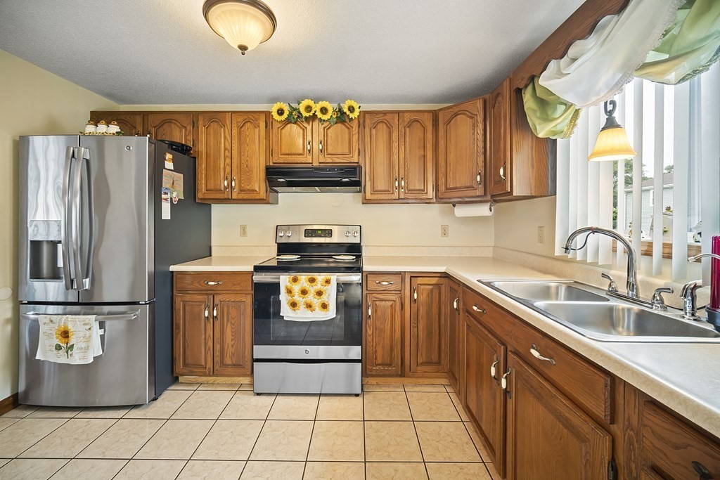 44 Judson Street Fall River, MA 02721 - Photo 9 of 31 a kitchen with stainless steel appliances granite countertop a refrigerator a stove a sink and a microwave
