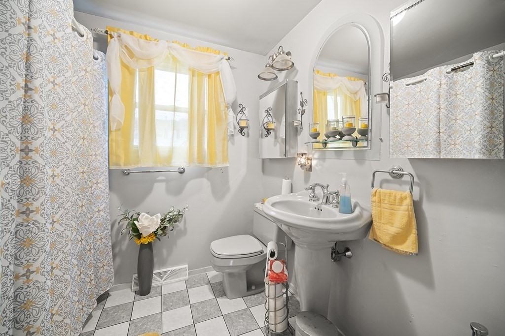 44 Judson Street Fall River, MA 02721 - Photo 10 of 31 a bathroom with a sink toilet and mirror
