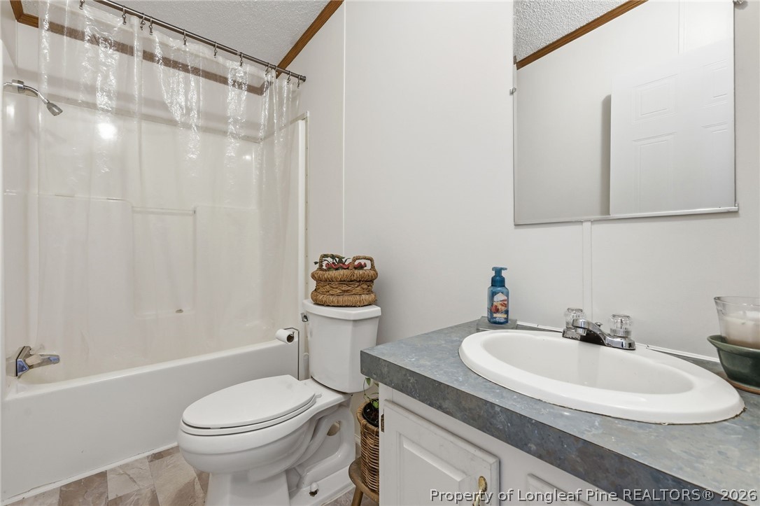 10400 Ruth Vinson Road Autryville, NC 28318 - Photo 36 of 49 a bathroom with a sink toilet and shower