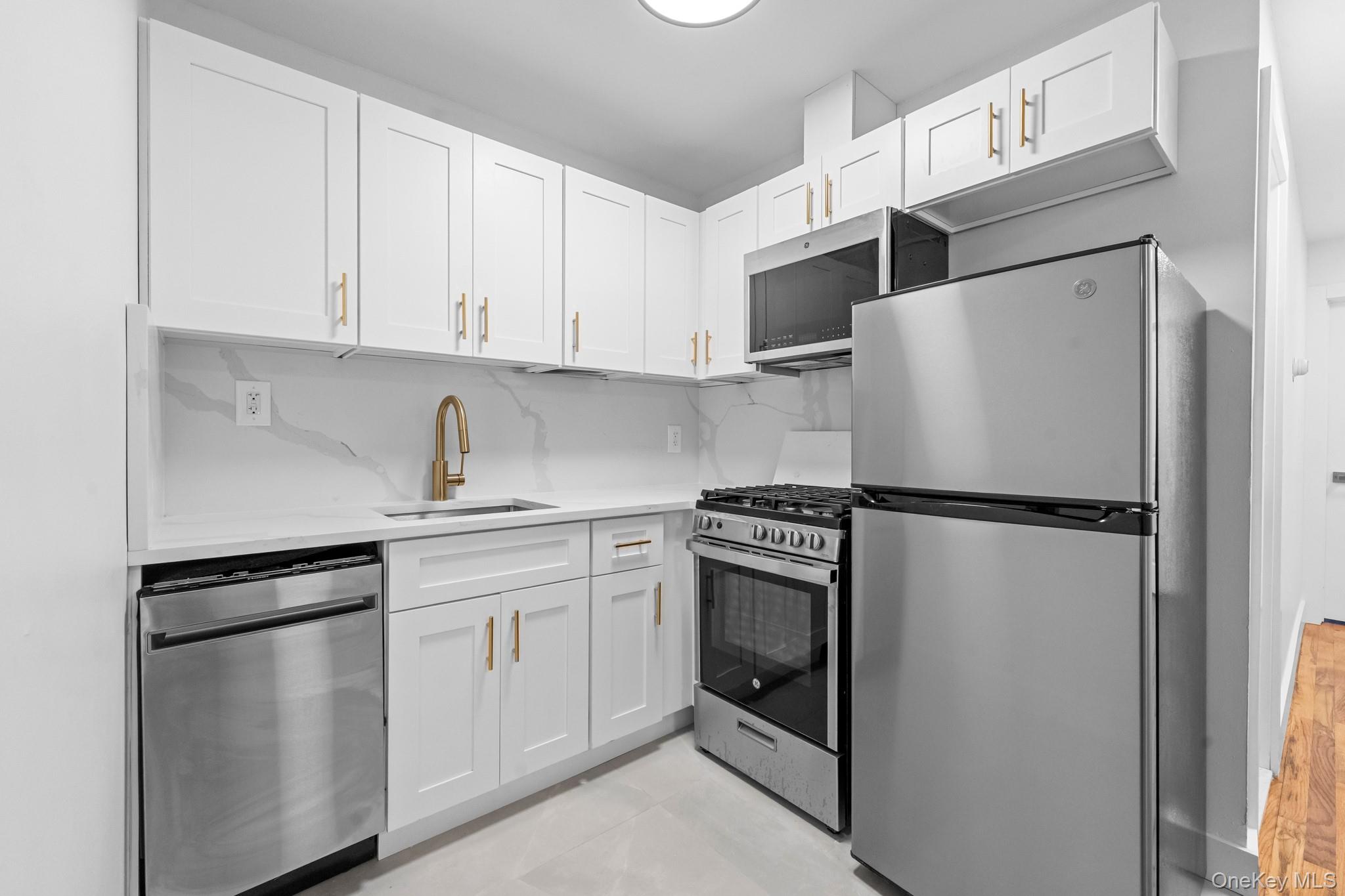 83-32 159th Street Queens, NY 11432 - Photo 3 of 15 a white refrigerator freezer sitting in a kitchen