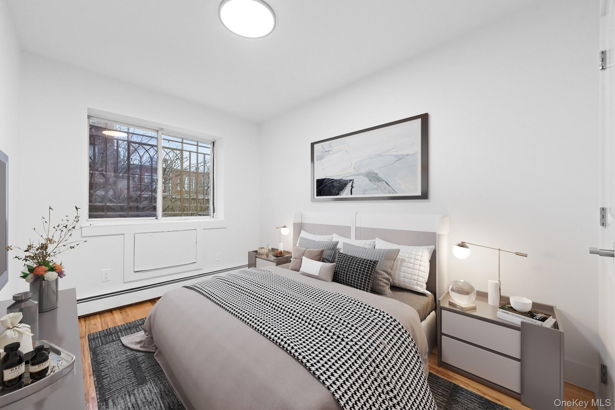 83-32 159th Street Queens, NY 11432 - Photo 7 of 15 a bedroom with bed and window