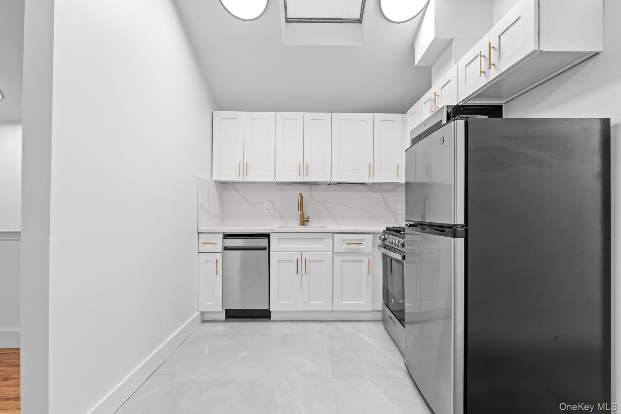 83-32 159th Street Queens, NY 11432 - Photo 9 of 15 a kitchen with stainless steel appliances granite countertop a refrigerator and a stove