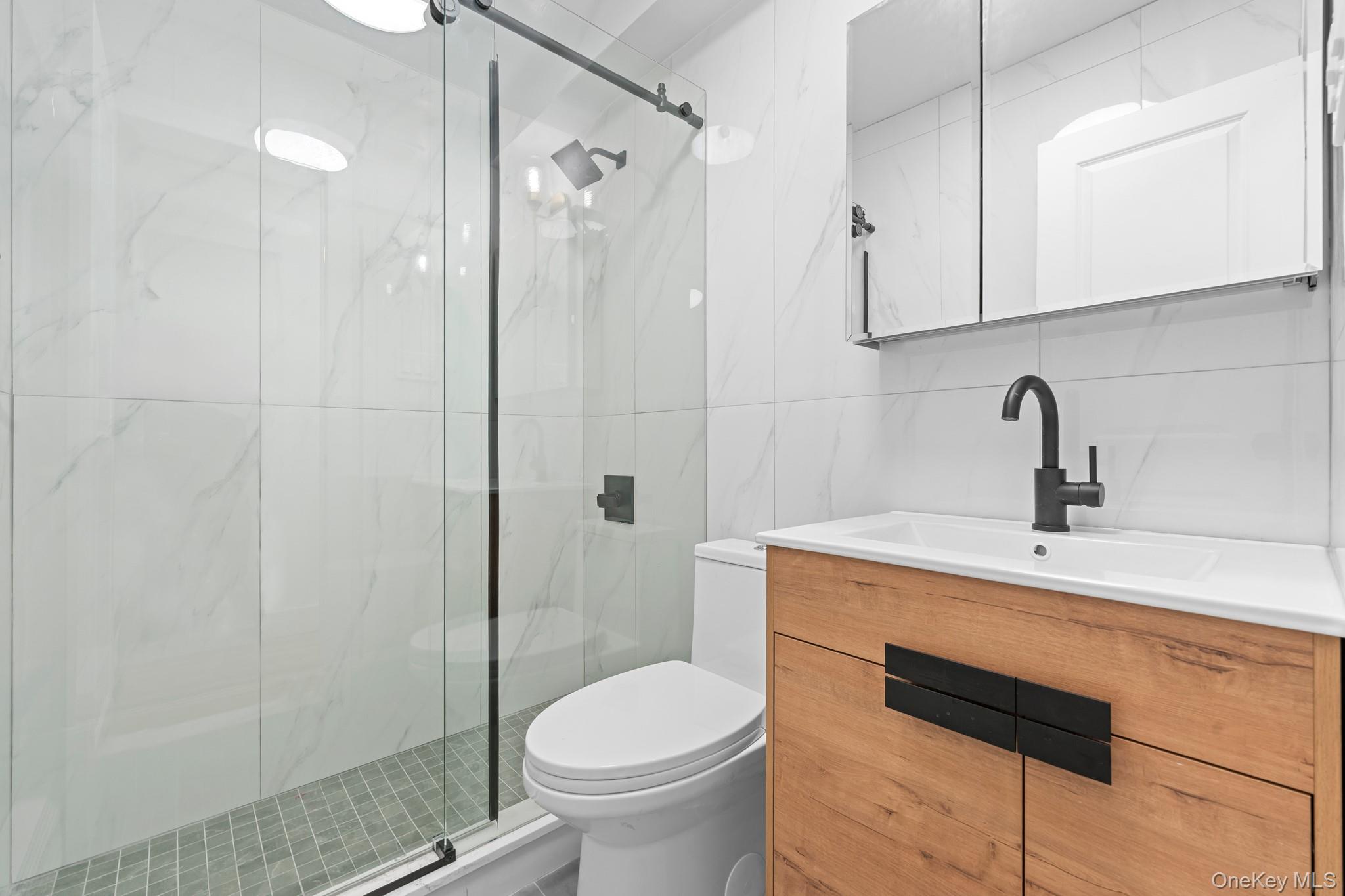 83-32 159th Street Queens, NY 11432 - Photo 10 of 15 a bathroom with a sink toilet and shower