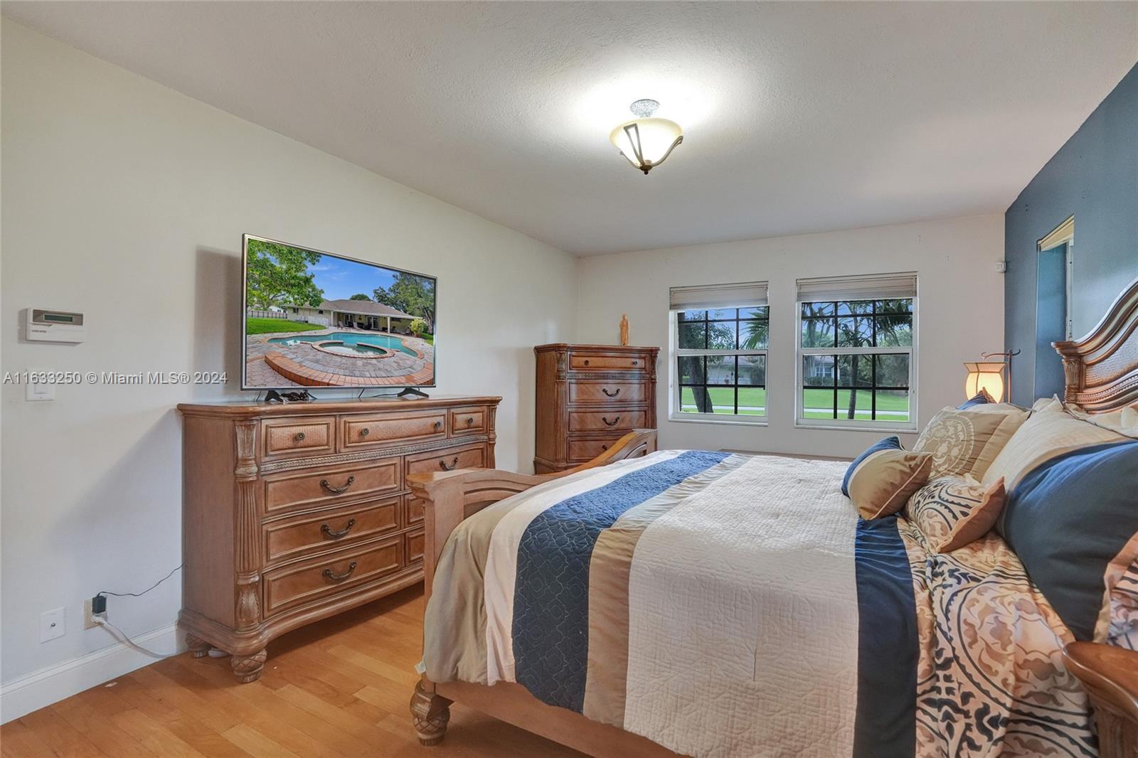 16630 Southwest 62nd Street Southwest Ranches, FL 33331 - Photo 19 of 33 a bedroom with a bed and furniture