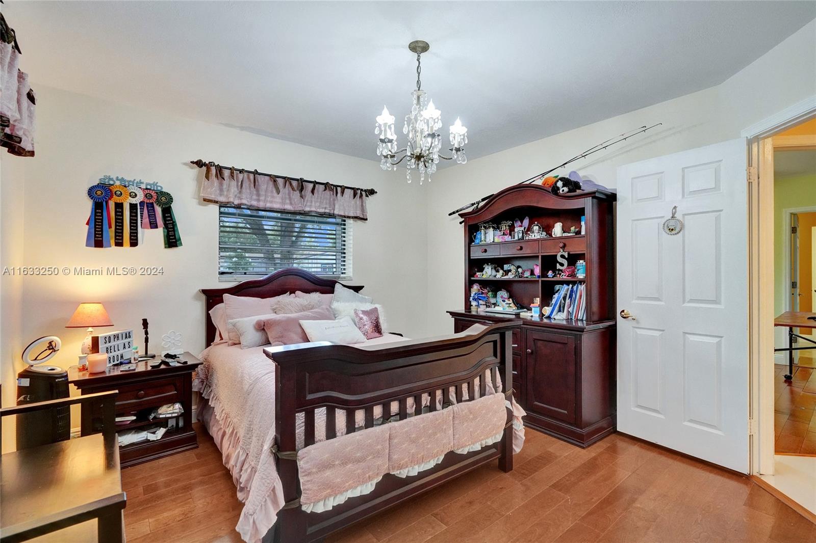 16630 Southwest 62nd Street Southwest Ranches, FL 33331 - Photo 22 of 33 a bedroom with furniture and a chandelier