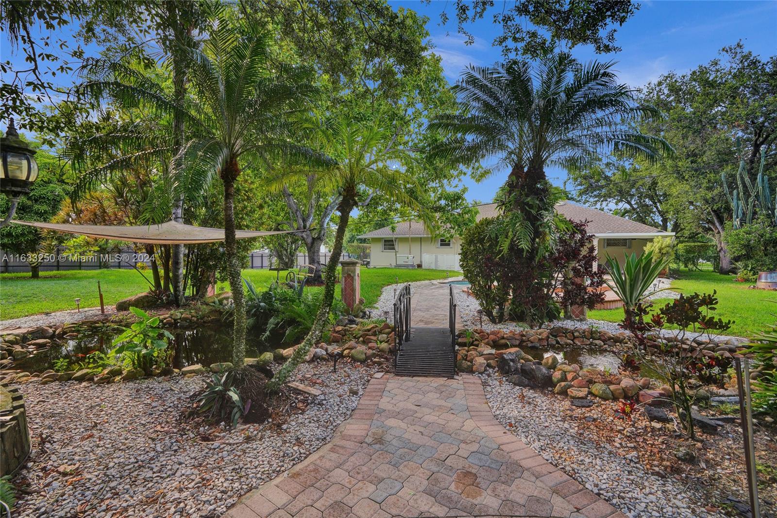 16630 Southwest 62nd Street Southwest Ranches, FL 33331 - Photo 31 of 33 a view of a backyard with plants and a barbeque