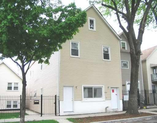 a view of a house with a large tree
