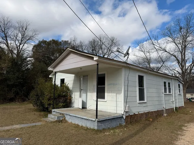 a view of a house with a tree